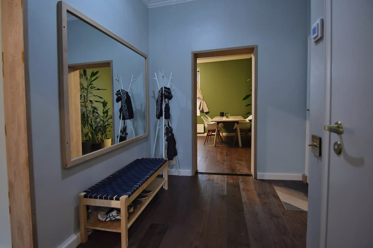 Entrance hallway with oak mirror, bench, and coat rack